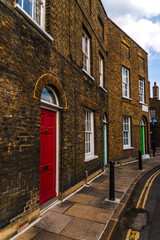 Fototapeta premium Typical old English buildings, low brick buildings across a narrow street, interesting old London architecture