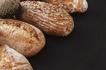 Bakery concept. Plenty of bread background isolated on balck