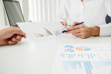 Business concept. Business people discussing the charts and graphs showing the results of their successful teamwork.