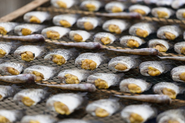 Traditional salted fish drying on racks and have sale in the market in asia