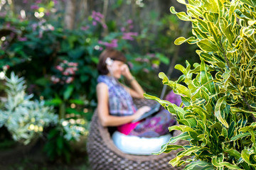 Obraz premium Young beautiful woman working with laptop at outdoor tropical park, smile and happy relaxing feeling in the morning, freelancer working businesswoman lifestyle concept. Bali island, Indonesia.