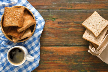 Breakfast background, toast and coffee on rustic wood, top view