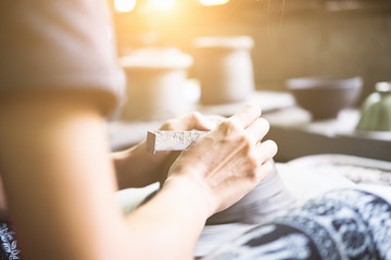 Hands of craftsman artist making craft, pottery, sculptor from fresh wet clay on pottery wheel, Modeling of pottery on the potter's wheel. selected focus