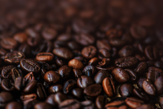 Dark Roasted Coffee Beans Espresso wallpaper with brown colored copyspace  close up. Fried  Coffee Beans Texture macro