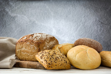 Mixed bread on white wooden background.Copyspace

