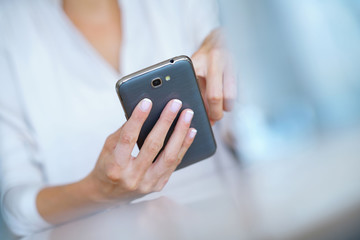Closeup of woman' s hand using smartphone