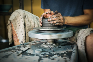 Hands of craftsman artist making craft, pottery, sculptor from fresh wet clay on pottery wheel, Modeling of pottery on the potter's wheel. selected focus