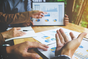 Business concept. Business people discussing the charts and graphs showing the results of their successful teamwork.
