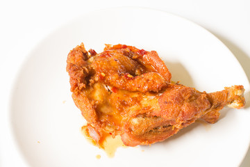 crispy  fried chicken in  the white dish on a wooden table , close up delicious fried chicken , close up
