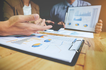 Business concept. Business people discussing the charts and graphs showing the results of their successful teamwork.