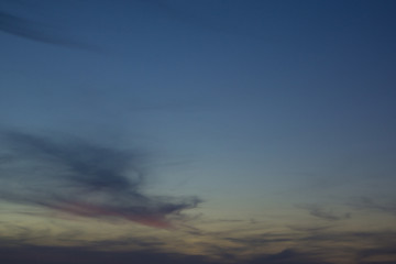 Seagulls flying in a colorful sky when night falls
