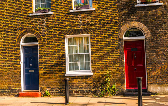 A Row of Brick Buildings with Black Doors on a Street in London Stock Image  - Image of architecture, english: 189002149