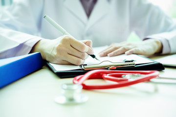 medicine doctor  working in hospital or pharmacist sitting at worktable, writing prescription on special form.Medical care and medical,Stethoscope with clipboard,pharmacy or insurance concept