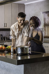 dinner preparation  kitchen cooking happy young mixed race couple