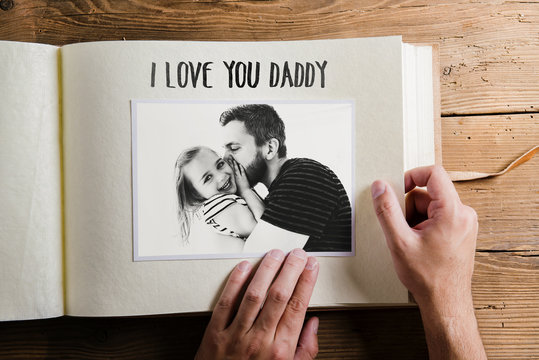 Fathers day concept. Photo album. Wooden background.