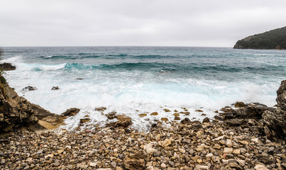 A rocky seascape during the windy day