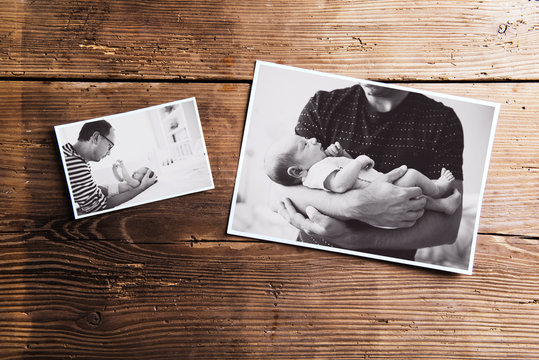 Pictures of father and baby, wooden background. Fathers day.