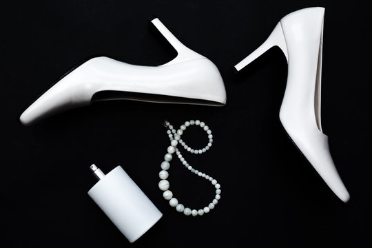 Stylish female accessories.white Shoes with perfume and accessories