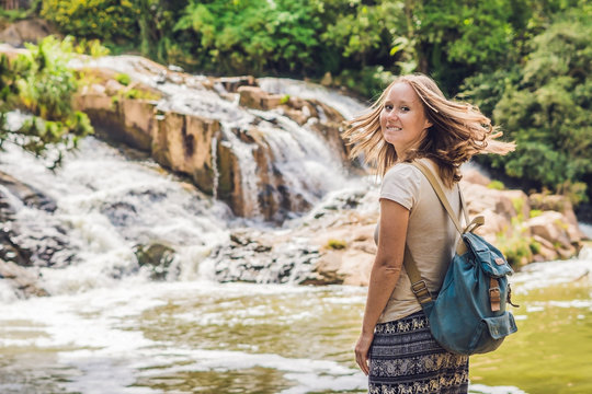 Young woman on the background of Beautiful Camly waterfall In Da Lat city