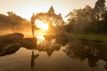 Silhouette yoga, Asia young woman practicing yoga in the forrest  and sport yoga,yoga relax,yoga in the park