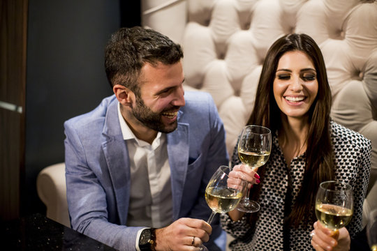 Cheerful young people toasting with white wine
