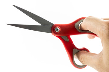 Hand holding red scissors isolated on white background