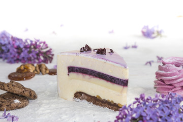 Beautiful piece of cake, marshmallow, cookies and caramel with nuts