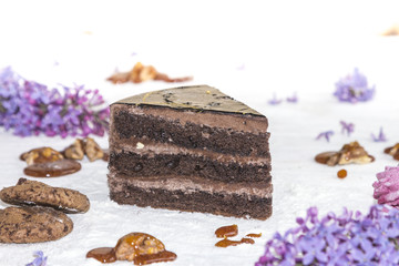 Beautiful piece of cake, cookies and caramel with nuts