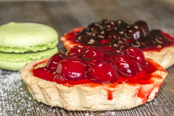 Confectionery basket with cherries, marshmallows and cake