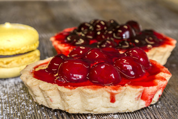 Confectionery basket with cherries, marshmallows and cake