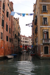 Clothes hanging out to dry between buildings over a Canal in Venice
