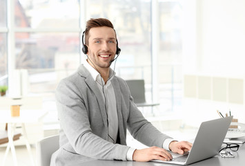 Handsome young man working in office © Africa Studio
