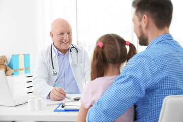 Little girl with father at doctor's office