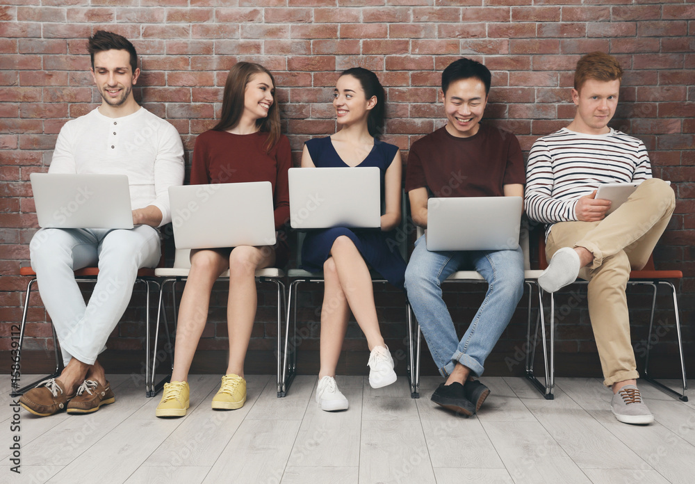 Poster Young people with gadgets sitting on chairs