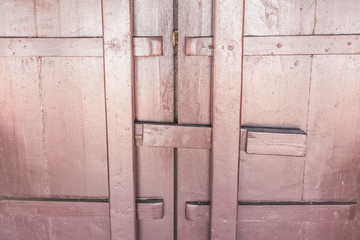 Closeup of old brown door on Thai temple, Asia.