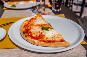 fresh warm pizza and table on street in italy 