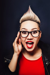 Woman close-up with glasses expresses surprise and happiness - obrazy, fototapety, plakaty