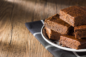 Pile of Chocolate Fudge Brownies on Wooden Table