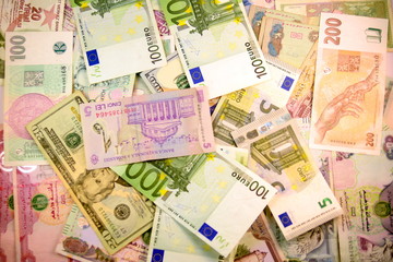 Different currency note and coins from different countries background