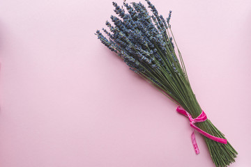 Lavender bouquet on pink background with copy space, flat lay