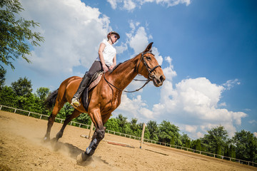 Young female riding a horse