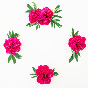 Frame of peony flowers and leaves on white background. Flat lay, top view. Pattern made of flowers