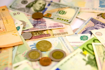 Different currency note and coins from different countries background
