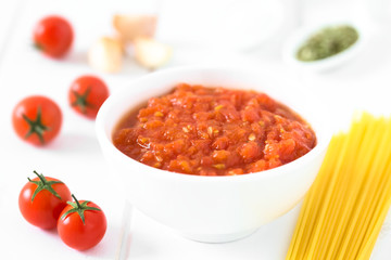 Homemade traditional Italian marinara or pomodoro tomato sauce made of fresh tomato, garlic, dried oregano and salt, photographed with natural light (Selective Focus in the middle of the sauce)