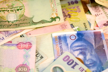 Different currency note and coins from different countries background