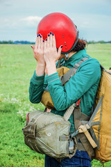 A civilian, young girl, with a parachute dressed, standing on th