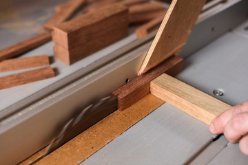 Circular saw sawing wood brick