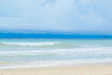 Fototapeta na wymiar Desert sand beach with blue sky and waves, Vietnam, Nha trang, South China sea