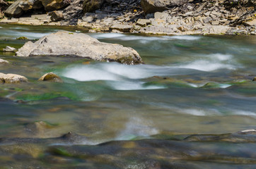 Background of Carpathian mountain river with long exposure