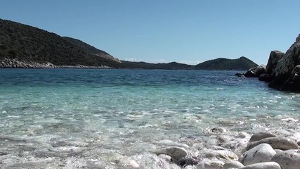 Blue cove, sea washing pebbles